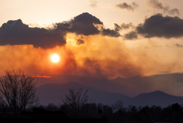 Smoke from a forest fire at sunset in the Appalachian Mountains in Polk County, North Carolina in 2025. 