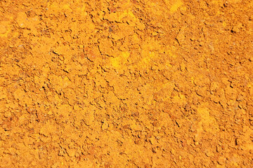 Yellow clay texture. Dry soil surface. Cracked desert ground. Earthy rough background. Natural...