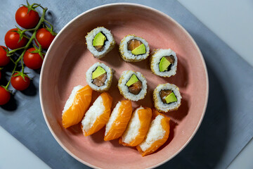 avocado and tuna Maki along with salmon sushi roll along with salmon nigiri