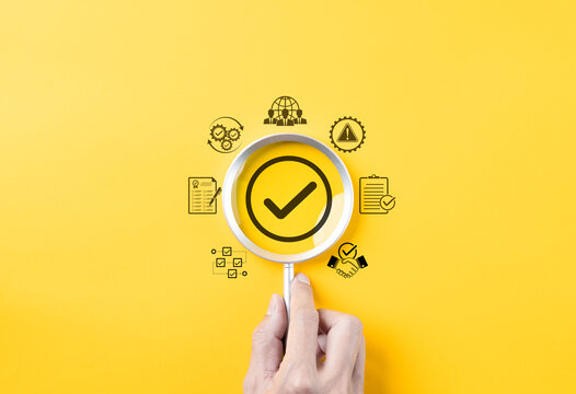 Quality assurance and compliance certification concept. Magnifying glass focusing on checkmark with quality, checklist, and compliance icons, assurance, verification, and quality management processes.