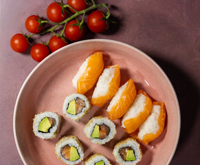 avocado and tuna Maki along with salmon sushi roll along with salmon nigiri