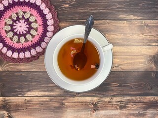 Cup of tea and crocheted doily mandala photo	