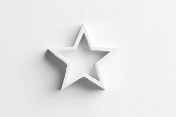 Obraz premium Creative star-shaped cookie cutter made from white material on a light surface