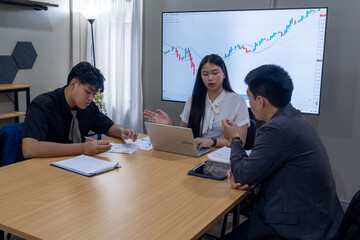 Fototapeta premium Business meeting focuses on financial analysis with team discussing data and trends in a modern office environment