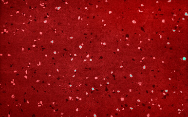 red terrazzo texture with scattered white flecks, suitable for backgrounds or interior design...