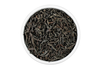 Dry black tea leaves in ceramic bowl isolated on white background. Top view. Flat