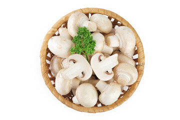 Fresh mushroom champignon in a wicker basket isolated on white background. Top view. Flat lay.