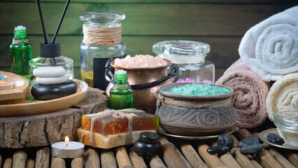 Spa treatment with candles and towel on wooden table, closeup