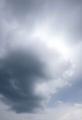group of people standing on top of a beach under a cloudy sky