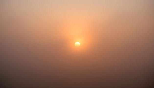 sun is shining through the foggy sky