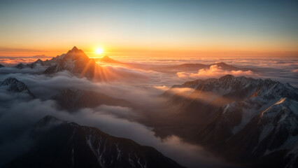 A majestic sunrise over misty mountain peaks: nature's serene beauty at dawn