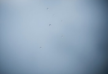 group of drops of water on a blue sky