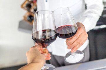 Glass of red wine in hands. Selective focus.