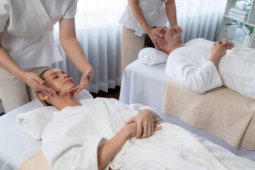 Caucasian couple enjoying relaxing anti-stress head massage and pampering facial beauty skin...