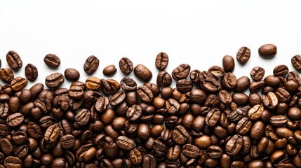 Fototapeta premium Roasted coffee beans scattered on white background