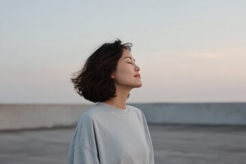 portrait of young asian woman meditating on rooftop scar from surgery visible on her chest
