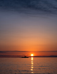A boat on the sea at sunset