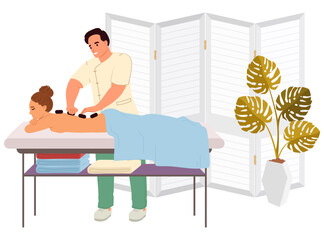 A skilled therapist applies hot stones on the back of a woman receiving a massage in a calm spa environment. Soft colors and indoor plants enhance the relaxing atmosphere.