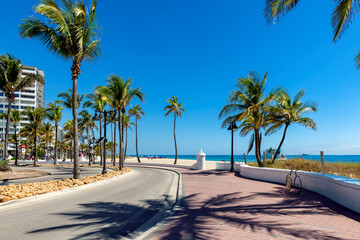 Seafront promenade and wonderful beach with palm trees on a sunny summer day in Fort Lauderdale beach, Florida