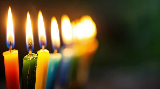 Colorful Hanukkah candles burning in a row. Bright flames and tradition. Symbol of Jewish celebration, light and cultural unity.
