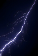 lightning strike is shown in the dark sky