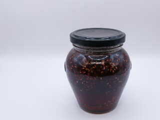 Small jar of strawberry jam made by mom at home, side view