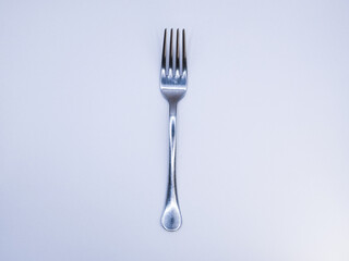 Large Ukrainian fork, lying on a white background, top view