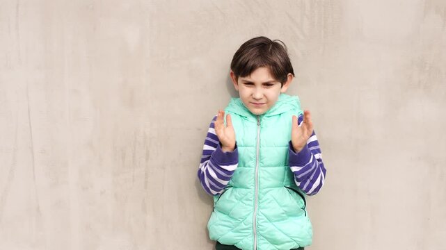 8 years boy wih ADHD walks outdoor at the backyard