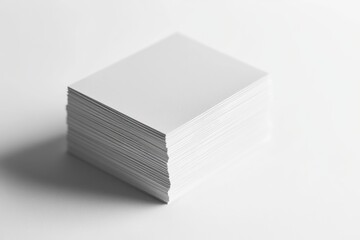 A stack of blank white square cards, neatly arranged on a white background.
