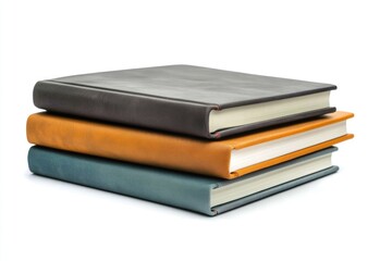 A stack of three hardcover books with different colors and textures, neatly arranged.