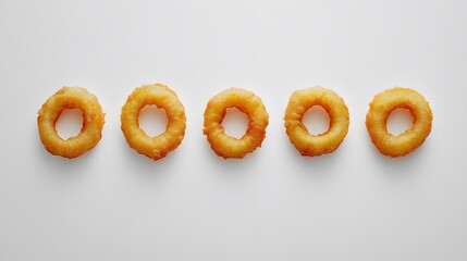 Five golden-brown fried calamari rings arranged in a row on a white background.  Perfect for menus or food blogs.