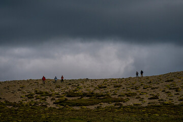Storm in the mountains while group of hikers comes down in Patagonia, Argentina