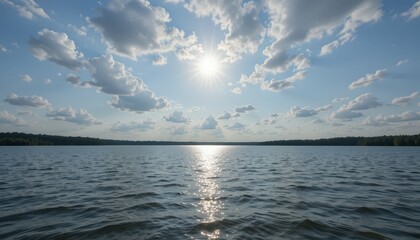 Obraz premium Serene Lake Under Bright Sun and Fluffy White Clouds in Sky