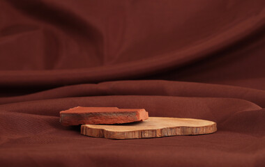Wooden stump and stone platform podium on brown silk fabric background. Minimal empty display...