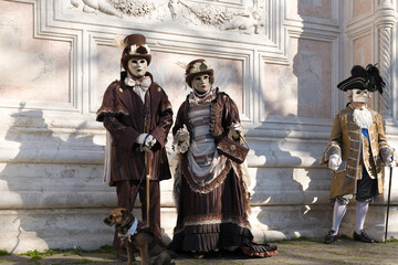 Venice, Italy - People dressed in carnival masks are photographed by tourists in the scenery of the...