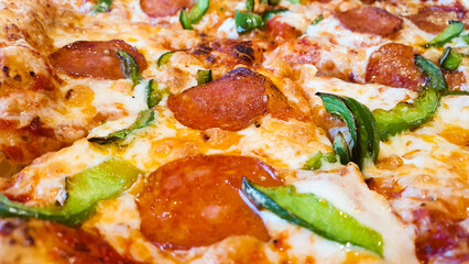 Pizza with sausage, peppers and cheese. Freshly cooked pizza on the table in a restaurant.