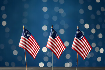 Three Small American Flags on Blue Bokeh Background