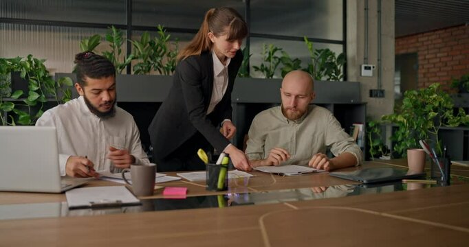 Businesswoman presents her report to colleagues at the start of a meeting sharing key data insights and project updates