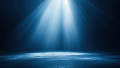 A bright beam of light shines down onto a dark blue surface.