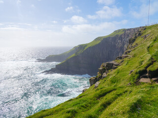 Suduroy Island, Faroe Islands, Denmark. View of the rocks, field and the ocean. A scenic place for travel. Photography for background, wallpaper, postcards.