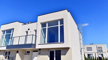 Terraced family homes in newly developed housing estate. The real estate market in the suburbs. New...
