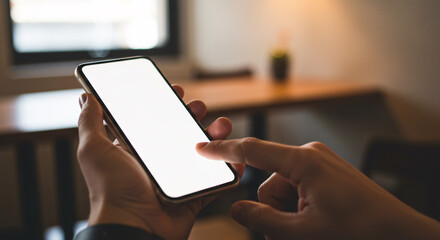 Hands Holding Smartphone with White Screen in Indoor Setting &ndash; Digital Communication Concept
