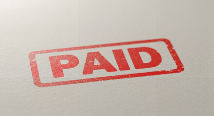 Distressed red "PAID" stamp impression on textured white paper background