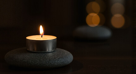 Calm candlelight meditation on pebbles in a serene background  