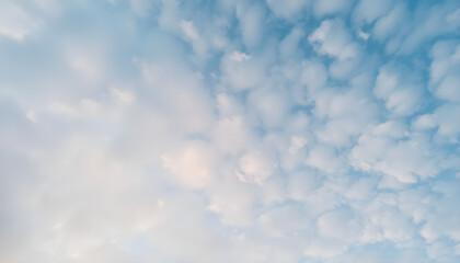 plane flying through a cloudy blue sky