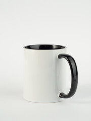 Two-tone 11oz mug on isolated background. Mug with black handle and inner part.