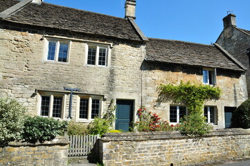 Old stone cottage houses on a street in an English town