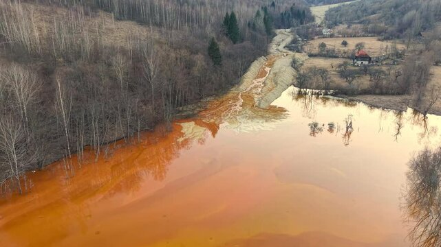 Drone scenic footage of the nature pollution and water contamination of the copper mine exploitation in Geamana, near Rosia Montana, Romania, Europe