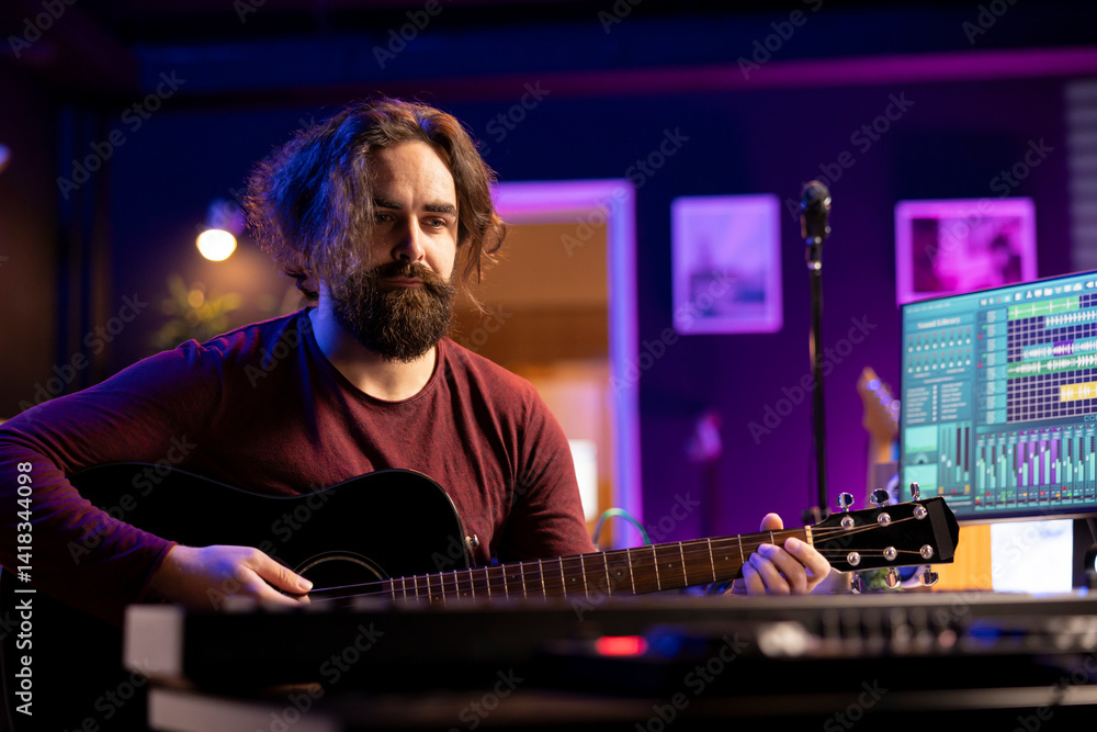 Poster musician plays acoustic guitar and records melody to compose new song and tunes. computer screen sho
