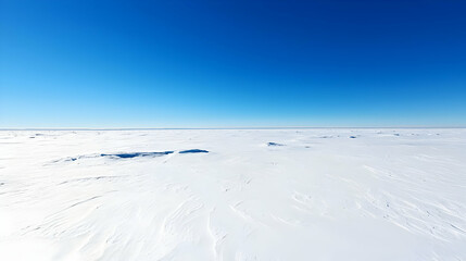 Obraz premium Vast Snowy Plains Under Clear Blue Sky